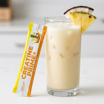 An iced Creatine Prime+ Pina Colada drink with a stick pack — the easy first sip